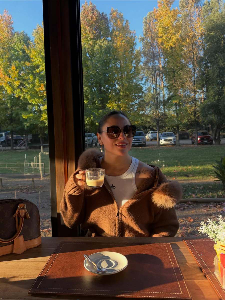 Customer in the brown cardigan with faux fur cuffs