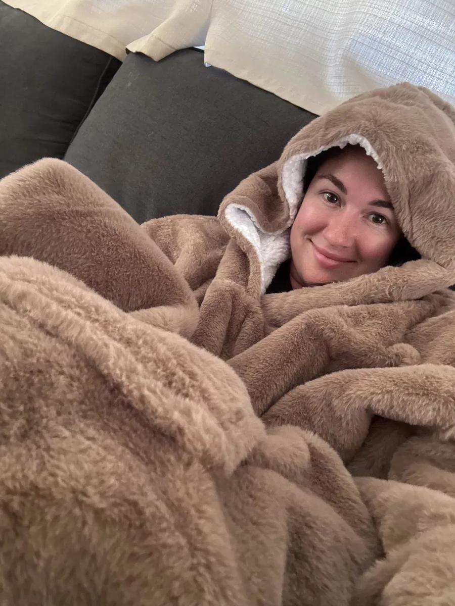 Customer wrapped in the mocha oversized hoodie blanket