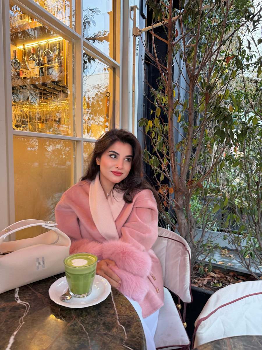 Customer in the blush pink coat with faux fur cuffs